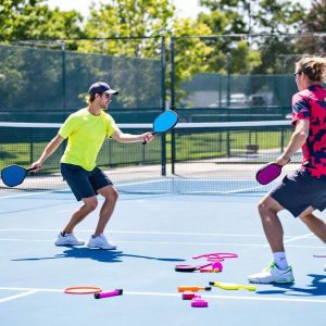 Players practicing pickleball control drills on the court.